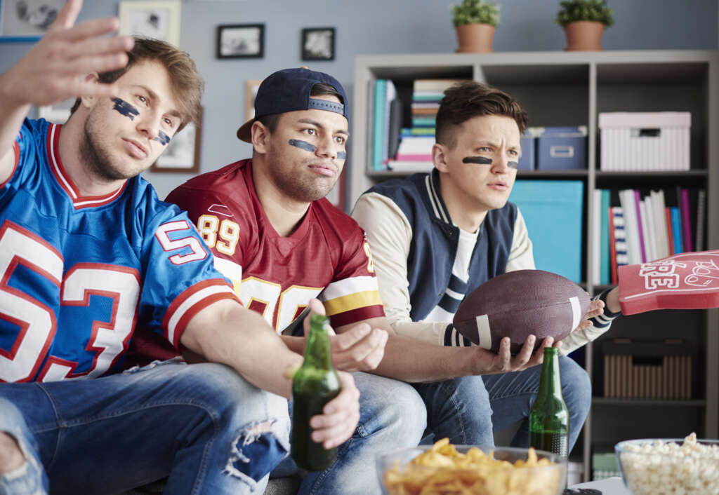 Fans watching a game together, the audience paid media has to reach