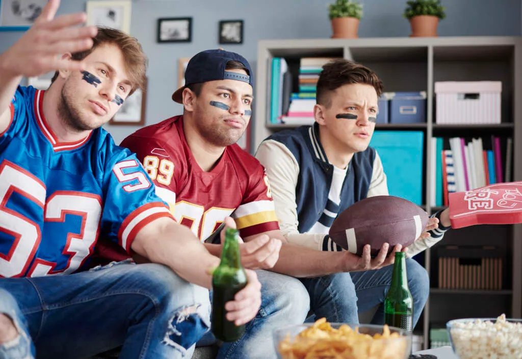 Fans watching a game together, the audience paid media has to reach